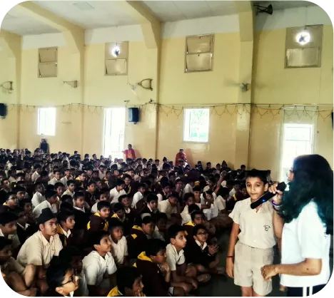 Students raising hands and interacting during a cyber awareness session